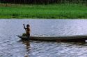 Brazillian boy paddles a canoe on the Amazon River, Brazil.