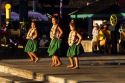 Young girls dressed in traditional clothes, perform the hula dance in Kauai, Hawaii.