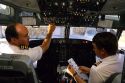 Pilot and co-pilot in the cockpit of a Boeing 737 commercial airplane.