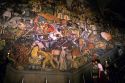 Visitors look at a Diego Rivera mural at the National Palace in Mexico City, Mexico.