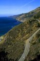 Automobiles drive on highway 1 along the pacific coast in Big Sur, California.