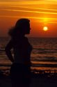 A woman silhouetted at sunset on the Florida Gulf Coast.