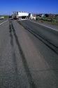 Traffic accident and skid marks from tires on the highway.