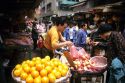 People shop at a traditional produce market in Hong Kong.
