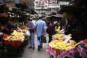 People shop at a traditional produce market in Hong Kong.