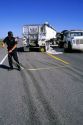 Police investigate traffic accident and measure skid marks from tires on the highway.