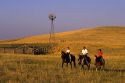 A ranch family riding horses on the prairie in Wyoming.