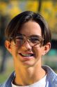American teenage boy wearing eye glasses and braces on his teeth.