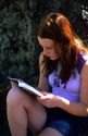 A teenage girl reading a book. MR