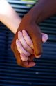 Interracial couple holding hands. MR