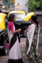 Indian women wearing saris talk on the street in Delhi, India.