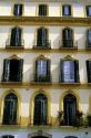 A building with shuttered windows at Plaza Merced housing Pablo Picasso's birthplace in Malaga, Spain.