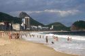 Visitors at the Copacabana Beach in Rio de Janeiro, Brazil with Sugar loaf rock in the left background.