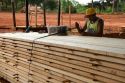 Worker banding lumber for drying at a lumber mill in Argentina.