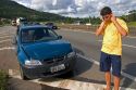 Brazilian man on a cell phone at the scene of a traffic accident near Sao Paulo, Brazil.