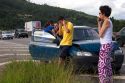 Brazilian man and woman using cell phones at the scene of a traffic accident near Sao Paulo, Brazil.