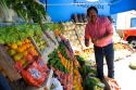 Merchant arranges artistic display of fruit and vegetables at a stand in Gesell, Argentina.