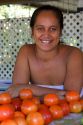 Tahitian woman selling tomatoes at a roadside stand on the island of Tahiti. MR