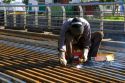 Construction worker welding on a bridge deck in Buenos Aires, Argentina.