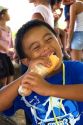 Tahitian boy eating a sandwich on the island of Moorea.
