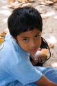 Young Tahitian boy having lunch on the island of Moorea.
