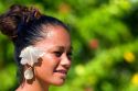 Tahitian woman wearing a tropical flower in her hair on the island of Moorea.