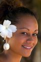 Tahitian woman wearing a tropical flower in her hair on the island of Moorea. MR