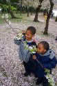 African american children smelling cherry blossoms near the Jefferson Memorial and Tidal Basin in Washington, D.C.