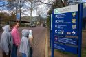 Children reading a sign at the entrance to the Smithsonian National Zoological Park in Washington, D.C.