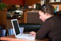 A woman using a laptop computer in a coffee shop, Boise, Idaho. MR