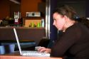 A woman using a laptop computer in a coffee shop, Boise, Idaho.