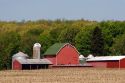 Red barn and buildings on farm near Ada, Michigan.