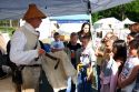 Lewis & Clark reenactor shows children how to tan a deer hide.  Park of a traveling exhibit of the National Park Service.