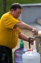 A man filling water jugs from a public water fountain in Hot Springs, Arkansas.
