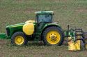 JJohn Deere tractor spraying a crop of cotton.