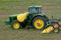 John Deere tractor spraying a crop of cotton.