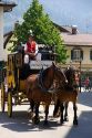 Street scene with a horse drawn stage coach in the alpine village of Garmisch, Germany.