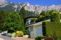 A house in Lichtenstein with the Swiss Alps in the background.