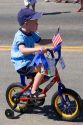 A young boy rides his bicycle in a small town Fourth of July parade in Cascade, Idaho.