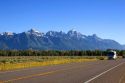 Morning view of Teton Mountains in Grand Teton National Park, Wyoming with a motorhome on the road.