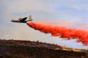 A  C-130 Hercules  airplane drops fire retardant on a fire in the Boise foothills, Idaho.
