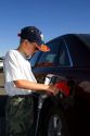 A nine year old boy pumps gasoline into a car at a gas station in Boise, Idaho. MR