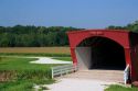 A red covered bridge in Madison County, Iowa.  Hogback Bridge.