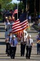 Veterans of Traer, Iowa march as honor guard in a parade for the Festival of the Spiral Steps.