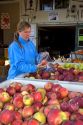 A woman shops for apples at a farmers market in Canyon County, Idaho. MR