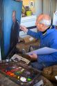 An artist painting a portrait on canvas in Boise, Idaho. MR