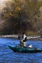 Fly fisherman on the South Fork of the Boise River in Idaho using a small pontoon boat.