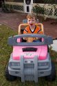 A three year old boy driving a battery powered car. MR