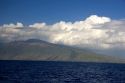 Clouds hang over the island of Maui, Hawaii.