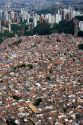 Aerial view of crowded favela housing contrasts with modern apartment buildings in Sao Paulo, Brazil.